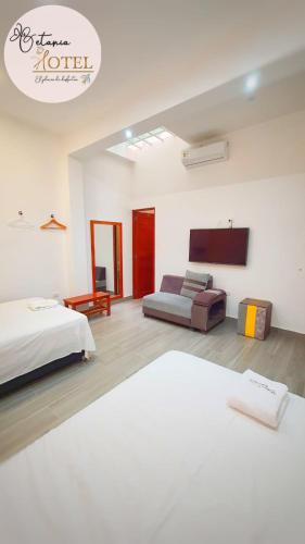 a bedroom with a bed and a couch in it at Hotel Betania in Jaén