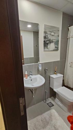 a bathroom with a sink and a toilet at Modern Space in Prime Location in Dubai