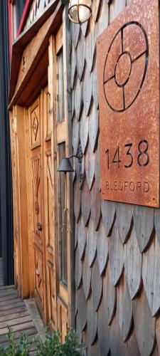 a sign on the side of a building with a door at Bledford Chiloé in Castro