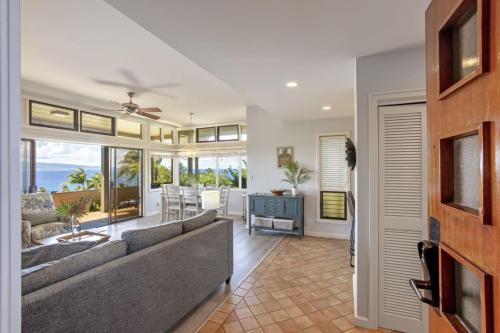 a living room with a couch and a table at Gorgeous Kapalua Home with Views in Kahana