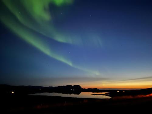 an image of the aurora borealis in the sky at Helgafell Guesthouse in Stykkishólmur