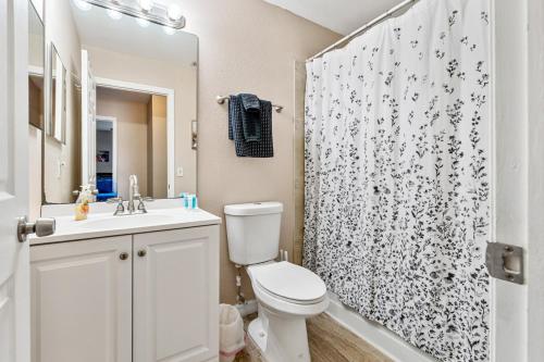 a bathroom with a toilet and a shower curtain at 3BR Coastal Escape Near Beaches, Golf, Shops in North Port