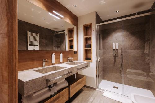 a bathroom with two sinks and a shower at Valtur Cervinia Cristallo Ski Resort in Breuil-Cervinia