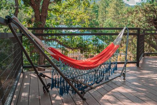 a hammock hanging from a fence on a deck at Charming Log AFrame in Pine in Pine