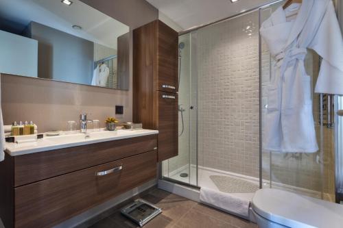 a bathroom with a shower and a sink and a toilet at Fraser Place Antasya Istanbul in Istanbul