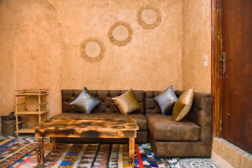 a living room with a brown couch and a table at Tangomar club kech in Marrakech