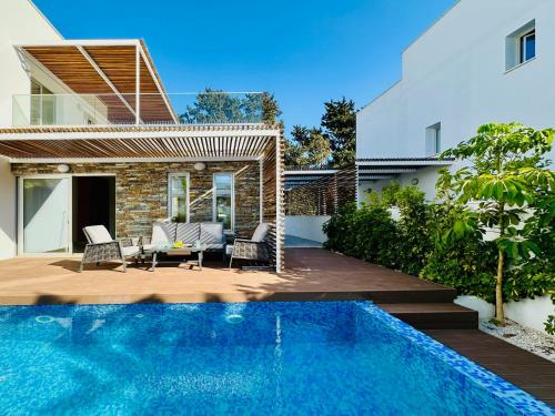 a backyard with a swimming pool and a house at Luxury Paradise Villa in Paphos