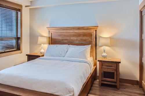 a bedroom with a large bed and two night stands at Stonegate Resort Unit B102 in Big White
