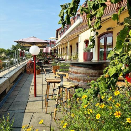 a patio with chairs and a table and an umbrella at Valuas in Venlo