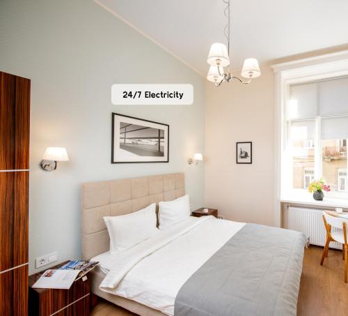 a bedroom with a bed and a sign that reads electricity at Art Deco Central Rooms in Lviv