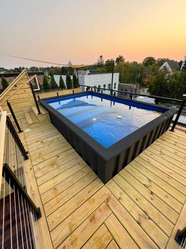 a large swimming pool on a wooden deck at Unit A, The Kroger Lofts in Charlevoix