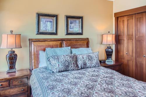 a bedroom with a bed with two night stands and two lamps at Stonegate Resort Unit C304 in Big White