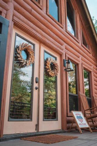 a front door of a house with wreaths on it at Charming Log AFrame in Pine in Pine