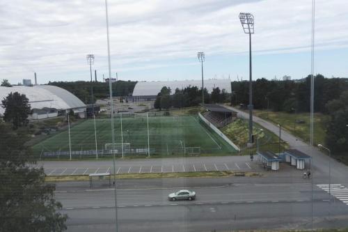 a car driving on a road near a soccer field at Nice 3-room-apartment next to Old Rauma & stadiums in Rauma