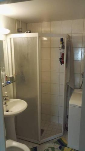 a bathroom with a shower and a toilet and a sink at Nice 3-room-apartment next to Old Rauma & stadiums in Rauma