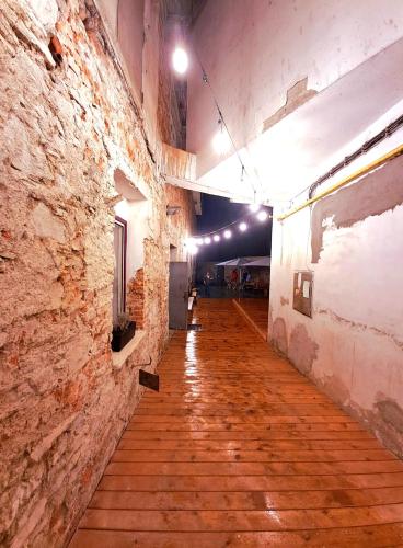 an empty hallway in an old building with wooden floors at Továrna Vír in Vír