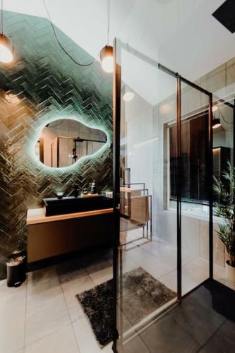 a bathroom with a sink and a mirror at Maroska Forest Cabin & Wellness in Kismaros