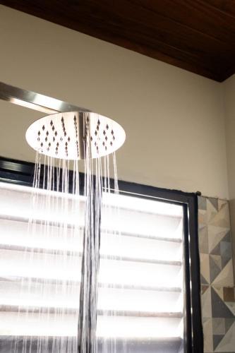 a light hanging from a ceiling next to a window at Hotel Boutique Bueso in Villanueva