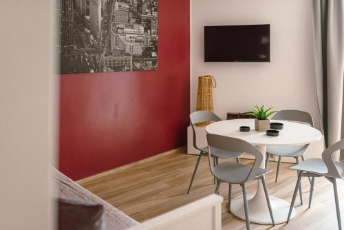 a dining room with a white table and chairs at Borgo Cavour Luxury Apartments - Centro storico in Fano