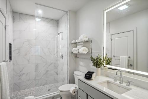 a bathroom with a sink and a toilet and a mirror at The Eleanor New Orleans in New Orleans