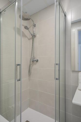 a shower with a glass door in a bathroom at Hotel Tolosa in Salou