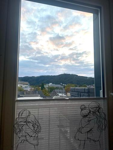 a window with two girls looking out of it at Modern Elegance in historical City Center in Trier