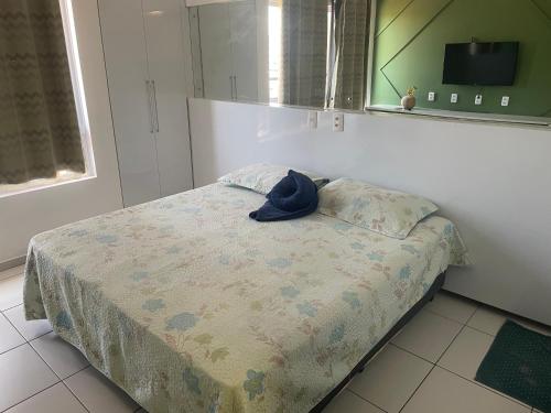 a bedroom with a bed with a hat on it at Smart Residence flat 803 in Teresina