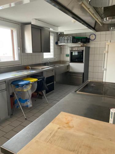 a kitchen with stainless steel counter tops and appliances at 13 - Gästehaus Erika - Hundwil - Appenzellerland in Hundwil