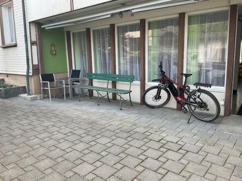 a bike parked next to a bench and a table at 13 - Gästehaus Erika - Hundwil - Appenzellerland in Hundwil