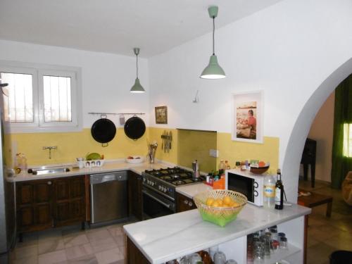 a kitchen with a sink and a stove top oven at Casa Ana in Carboneras