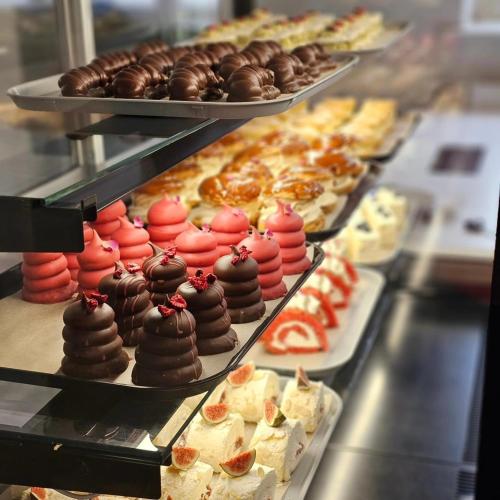 a display case filled with lots of different types of pastries at Továrna Vír in Vír