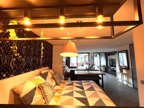 a living room with a bed and a dining room at Willemsbrug Vista in Schiedam