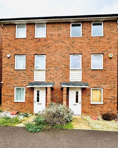 a red brick building with two white doors at Best Places to Stay in Kent in Kent