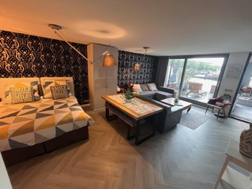 a bedroom with a bed and a living room at Willemsbrug Vista in Schiedam