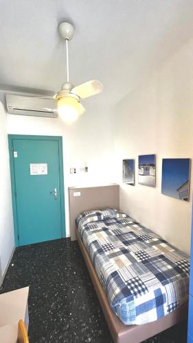 a bedroom with a bed and a ceiling fan at Hotel Al Capo in Varigotti