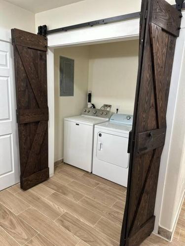 a laundry room with a washer and dryer and a door at Hitching Post in Vernal