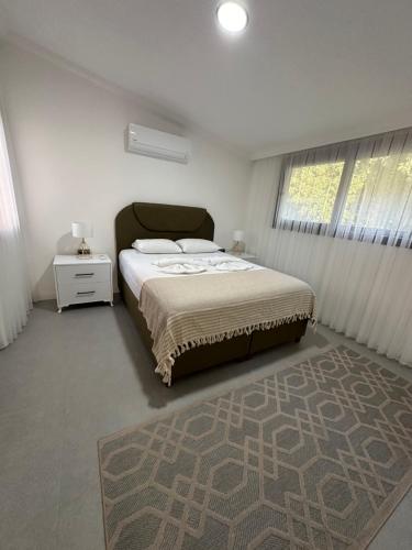 a bedroom with a large bed and a rug at Beach Suites - İçmeler in Icmeler