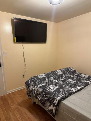 a bedroom with a flat screen tv on the wall at Nwk 457 RM 113-C in Newark