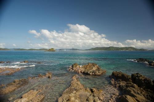 a view of the ocean with rocks in the water at Ocean Front Sapphire del Mar B-107 in St Thomas