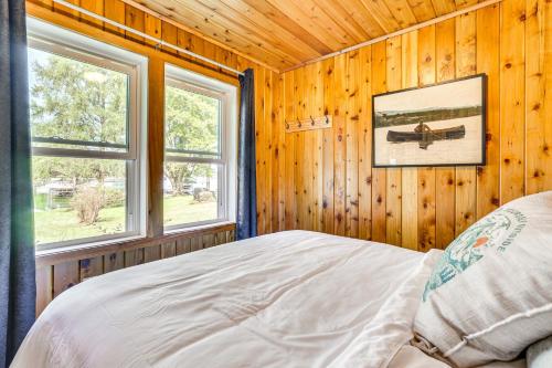 a bedroom with a bed and two windows at Hike, Fish, Unwind and Relax Lodi Lake Escape! in Lodi