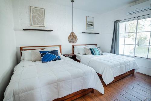 Ένα ή περισσότερα κρεβάτια σε δωμάτιο στο Cabo