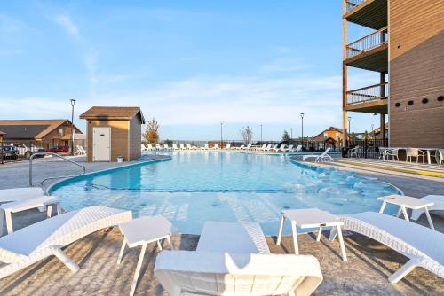 a large swimming pool with white chairs and tables at Table Rock Lake Views, Free Daily Attraction Tickets, Cmty Amenities w Pools in Kimberling City