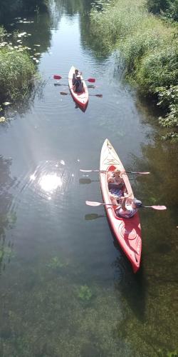 two kayaks in a river with people in them at Sosnówka Pokoje Gościnne in Borne Sulinowo