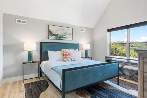 a bedroom with a blue bed and a desk at Table Rock Lake Views, Free Daily Attraction Tickets, Cmty Amenities w Pools in Kimberling City
