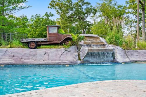 an old truck parked next to a water fountain at Finns and Family in Branson