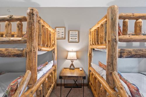 two bunk beds in a room with a table at Finns and Family in Branson