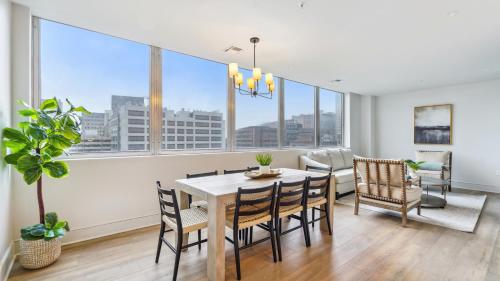 a dining room with a table and chairs and windows at The Eleanor New Orleans in New Orleans