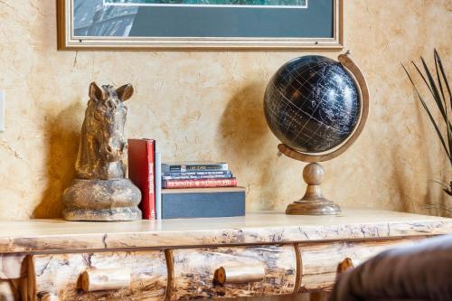 a table with a globe and books on it at Grin Inn Bear It in Branson