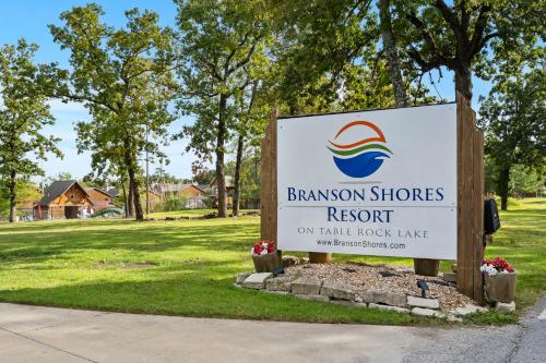 a sign for a baskin brothers resort in a park at Grin Inn Bear It in Branson