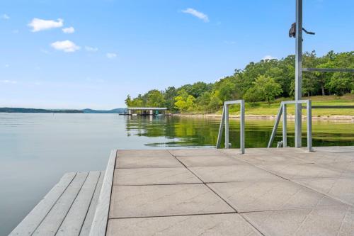 a dock with a view of a body of water at Grin Inn Bear It in Branson
